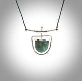 Hand crafted contemporary green jade and sterling silver drop necklace. This necklace is provided with a green adjustable cord. Contemporary green jade drop necklace with sterling silver.